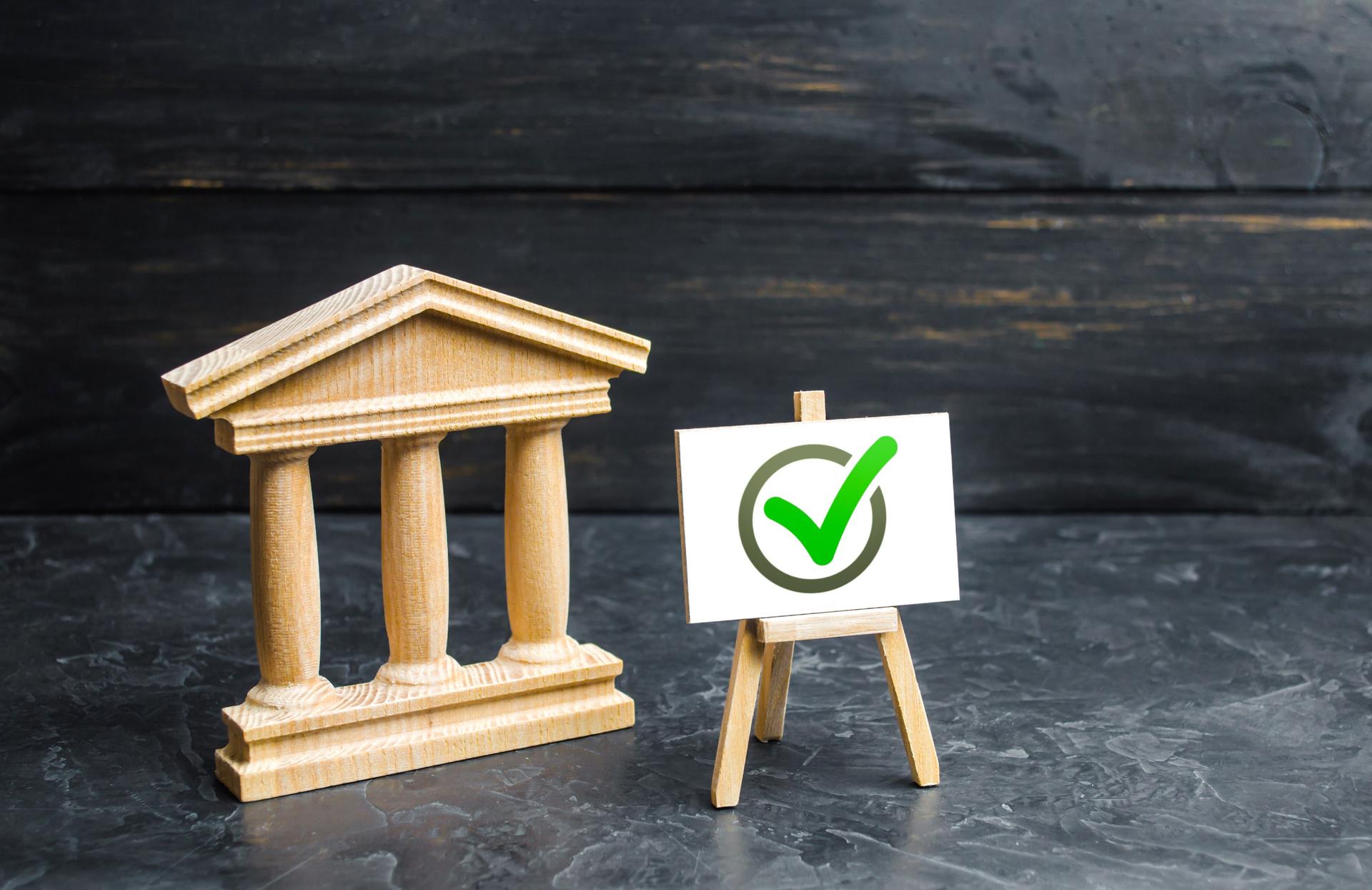 Government building a green vote tick. Implementation of the new law. The legitimacy of the government, an honestly elected government. Election concept. Removing restrictions and granting permits.